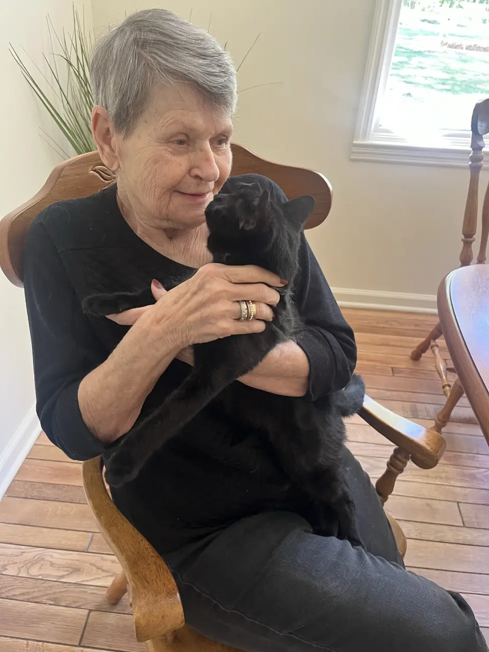 Resident holding cat Resident enjoying cuddle time with pet cat